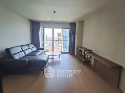 Spacious living room with modern furniture and city view balcony