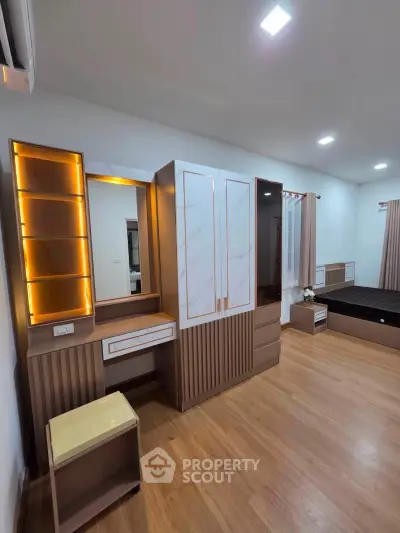 Modern bedroom with stylish wooden flooring and elegant furniture