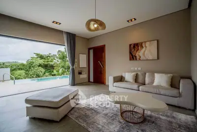 Luxurious living room with pool view and modern decor in a serene setting.