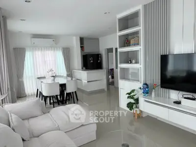 Modern living room with open layout, sleek furniture, and natural light, perfect for contemporary living.