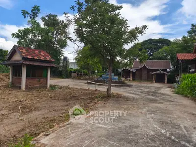 Charming rustic property with multiple small houses and lush greenery, perfect for serene living or investment.