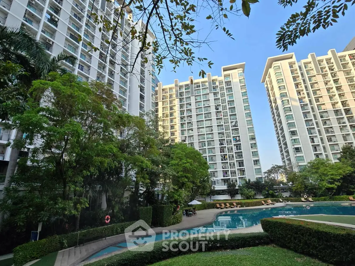 Luxurious high-rise apartment complex with lush gardens and inviting swimming pool.