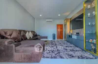 Spacious living room with plush sofa and modern entertainment unit