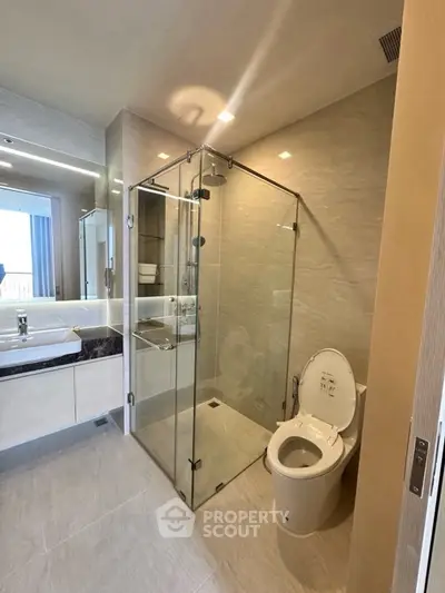 Modern bathroom with glass shower and sleek fixtures