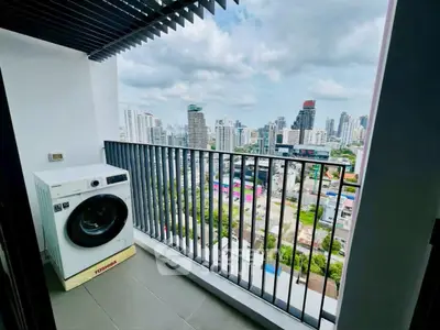Stunning city view from modern balcony with washing machine, perfect for urban living.