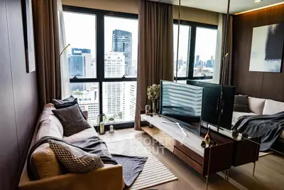 Modern living room with city view, stylish decor, and large windows in high-rise apartment.
