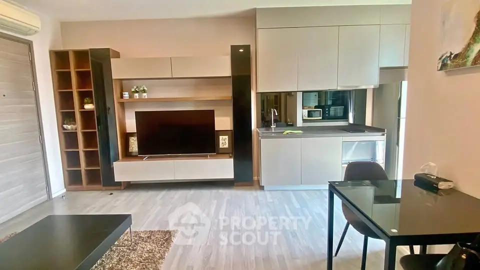 Modern living room with sleek furniture and integrated kitchen area, perfect for urban living.