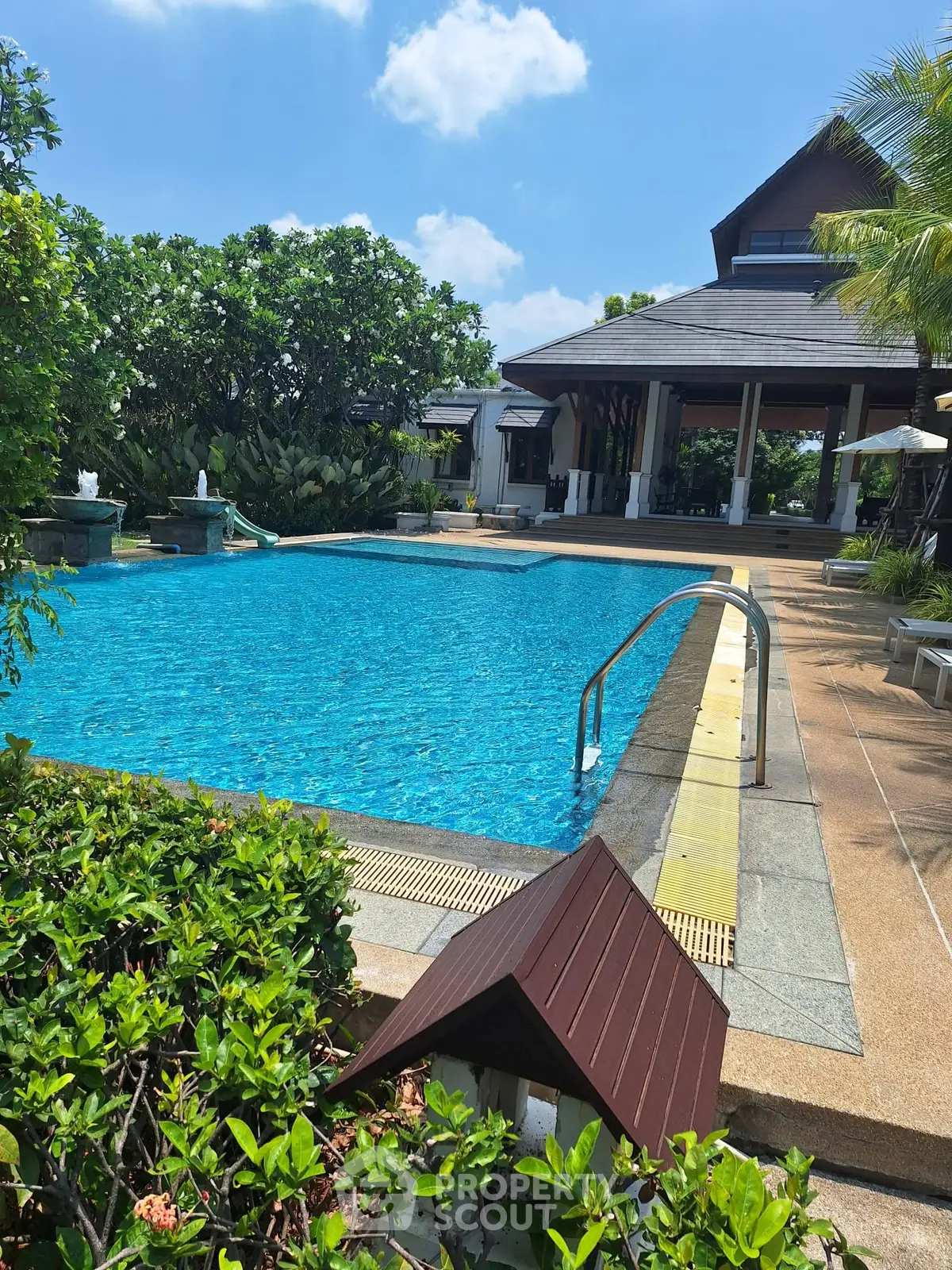 Luxurious villa with stunning pool and lush garden, perfect for relaxation and entertaining.