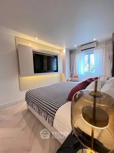 Luxurious modern bedroom with stylish decor and large window view