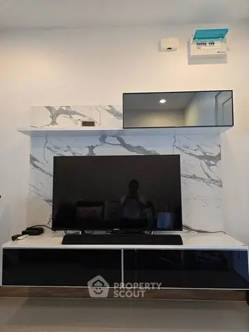 Modern living room with sleek TV unit and marble accent wall