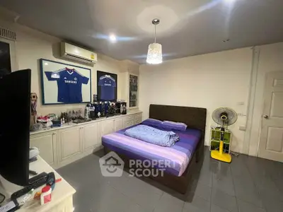Cozy bedroom with framed jerseys and modern decor
