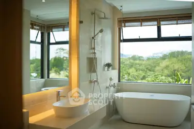 Luxurious bathroom with freestanding tub and scenic window view