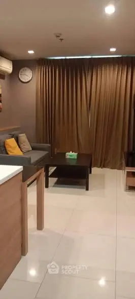 Modern living room with sleek furniture and ambient lighting, perfect for relaxation and entertainment.