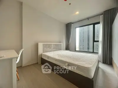 Modern bedroom with large window and minimalist design in urban apartment