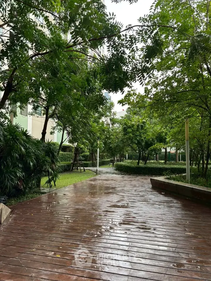 Lush garden pathway in a residential complex, perfect for serene walks and relaxation.