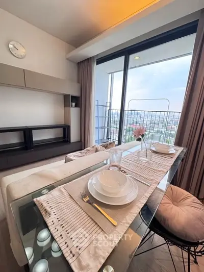 Stylish modern living room with dining area and stunning city view from balcony.