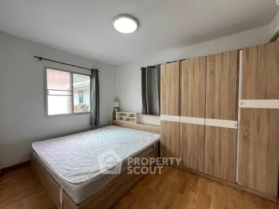Spacious bedroom with modern wooden furniture and natural light
