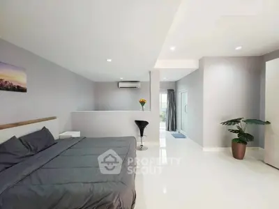 Spacious modern bedroom with sleek design and natural light