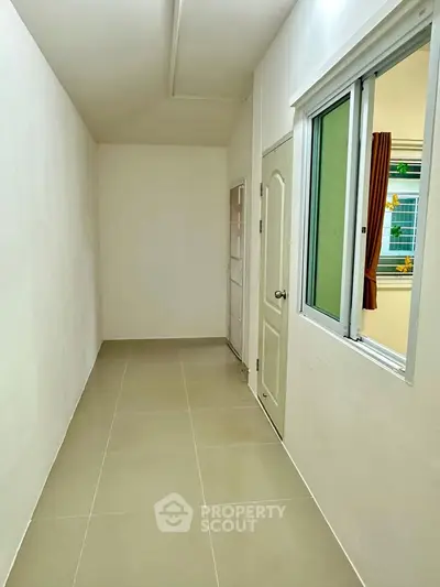 Spacious storage room with tiled flooring and window for natural light