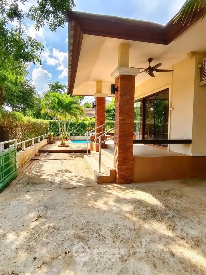 Charming home exterior with spacious patio and lush garden, perfect for outdoor relaxation and entertaining.
