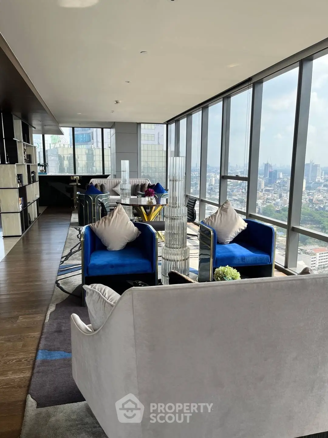 Luxurious high-rise living room with panoramic city views and modern furnishings.
