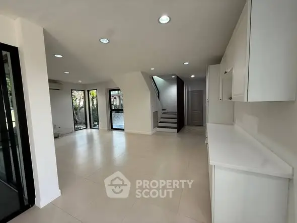 Spacious modern living room with open layout and sleek design, perfect for family gatherings.