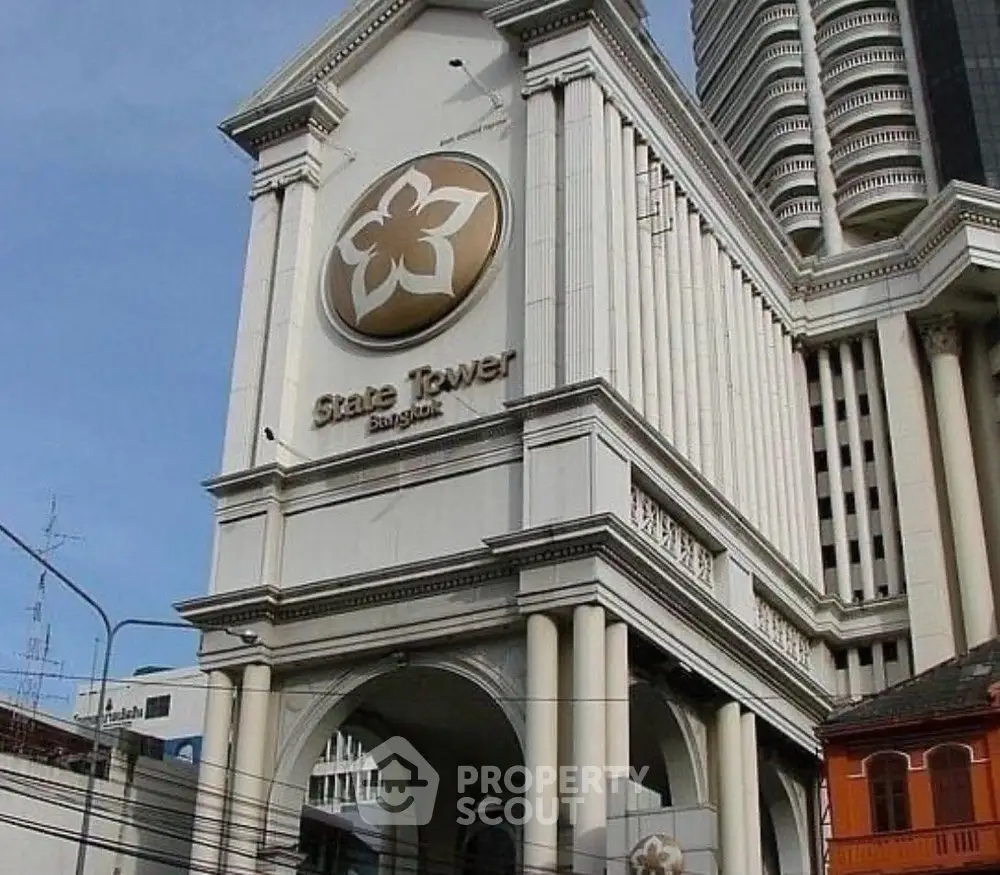 Iconic State Tower Bangkok with grand architectural design and prominent gold emblem.