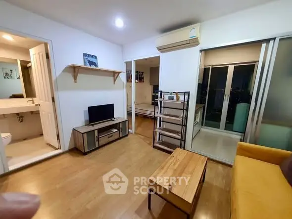 Modern living room with wooden flooring and balcony access