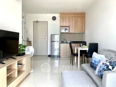 Modern open-plan living room with sleek kitchen and cozy seating area, perfect for urban living.