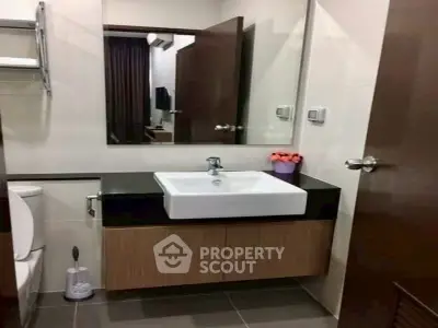 Modern bathroom with sleek vanity and mirror in stylish apartment