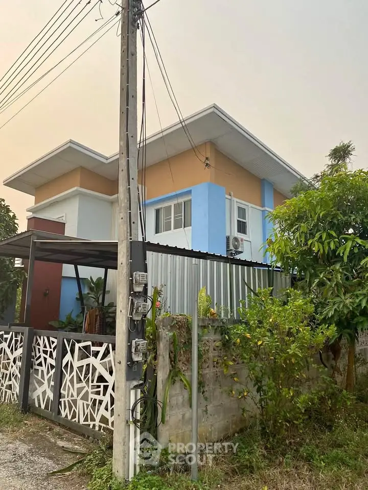 Charming two-story house with modern design and colorful exterior in a serene neighborhood.