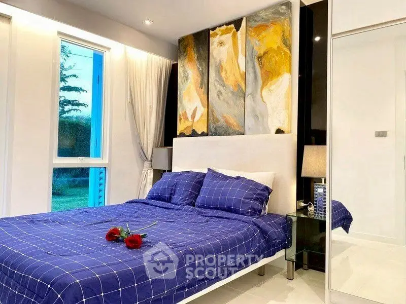 Elegant bedroom with modern art and cozy blue bedding