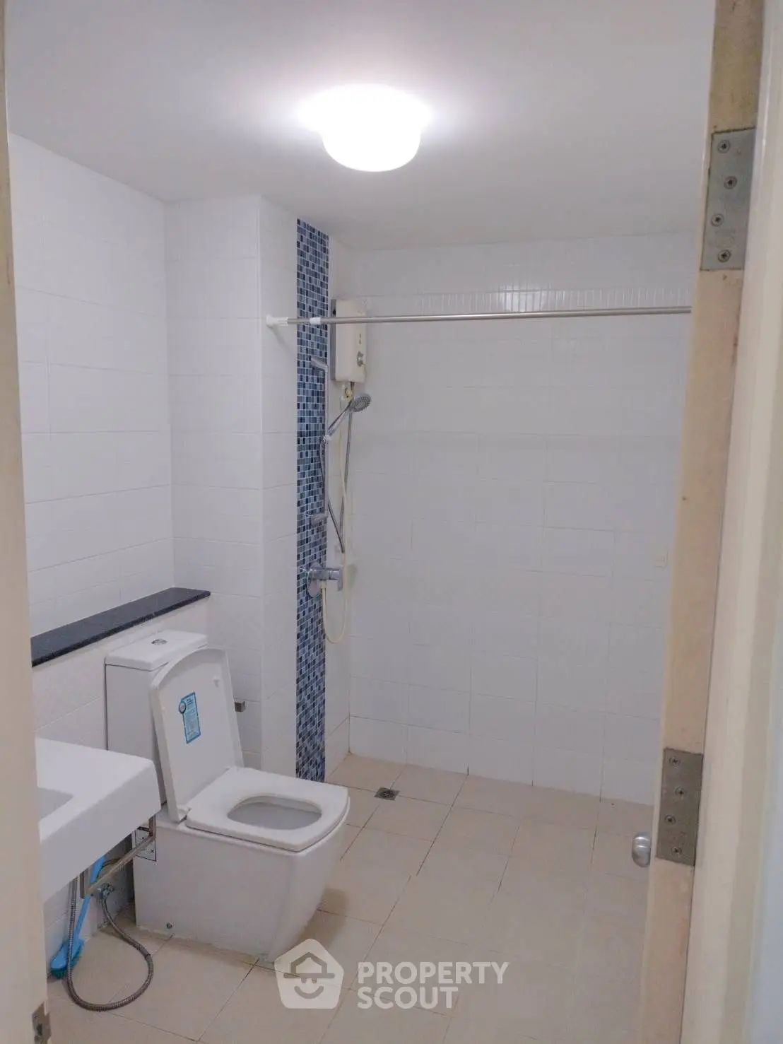 Spacious bathroom with modern fixtures and shower area