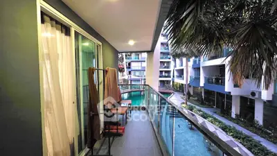 Spacious balcony with pool view in modern apartment complex