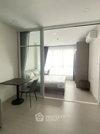 Modern studio apartment with glass partition and natural light