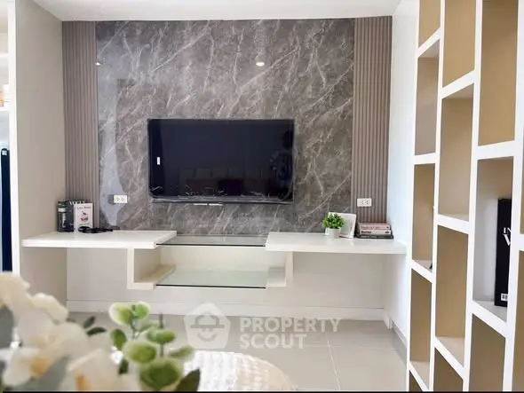 Modern living room with sleek TV wall and stylish shelving