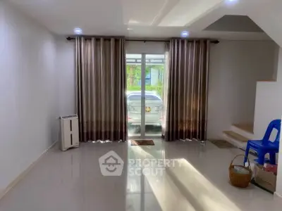Spacious living room with large windows and modern decor