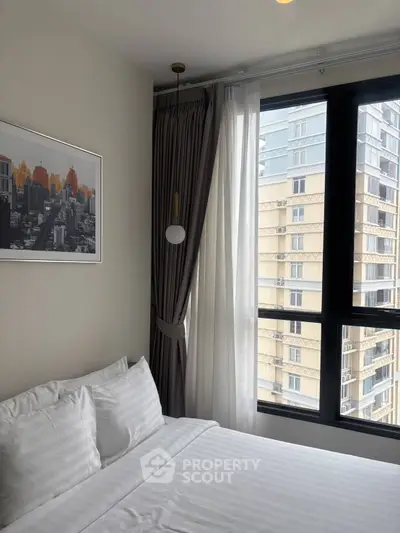 Modern bedroom with city view and elegant decor in high-rise apartment