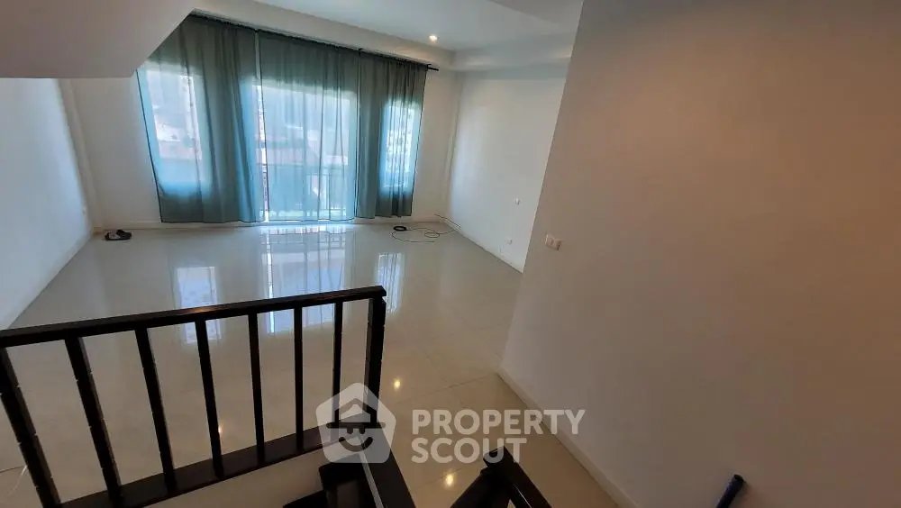 Spacious and well-lit corner unit with a large living area, glossy tiled flooring, and a balcony offering natural light, perfect for modern living.