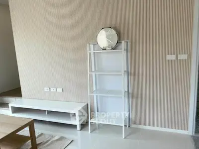 Modern minimalist living room with sleek shelving and neutral tones