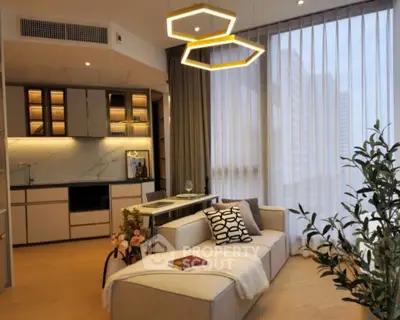 Modern living room with stylish lighting and open kitchen layout.