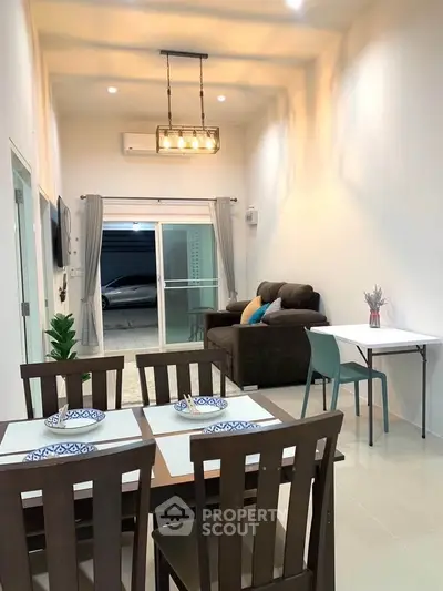 Modern living and dining area with stylish furniture and elegant lighting