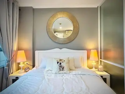 Cozy bedroom with elegant decor, featuring a plush bed, stylish lamps, and a decorative mirror.