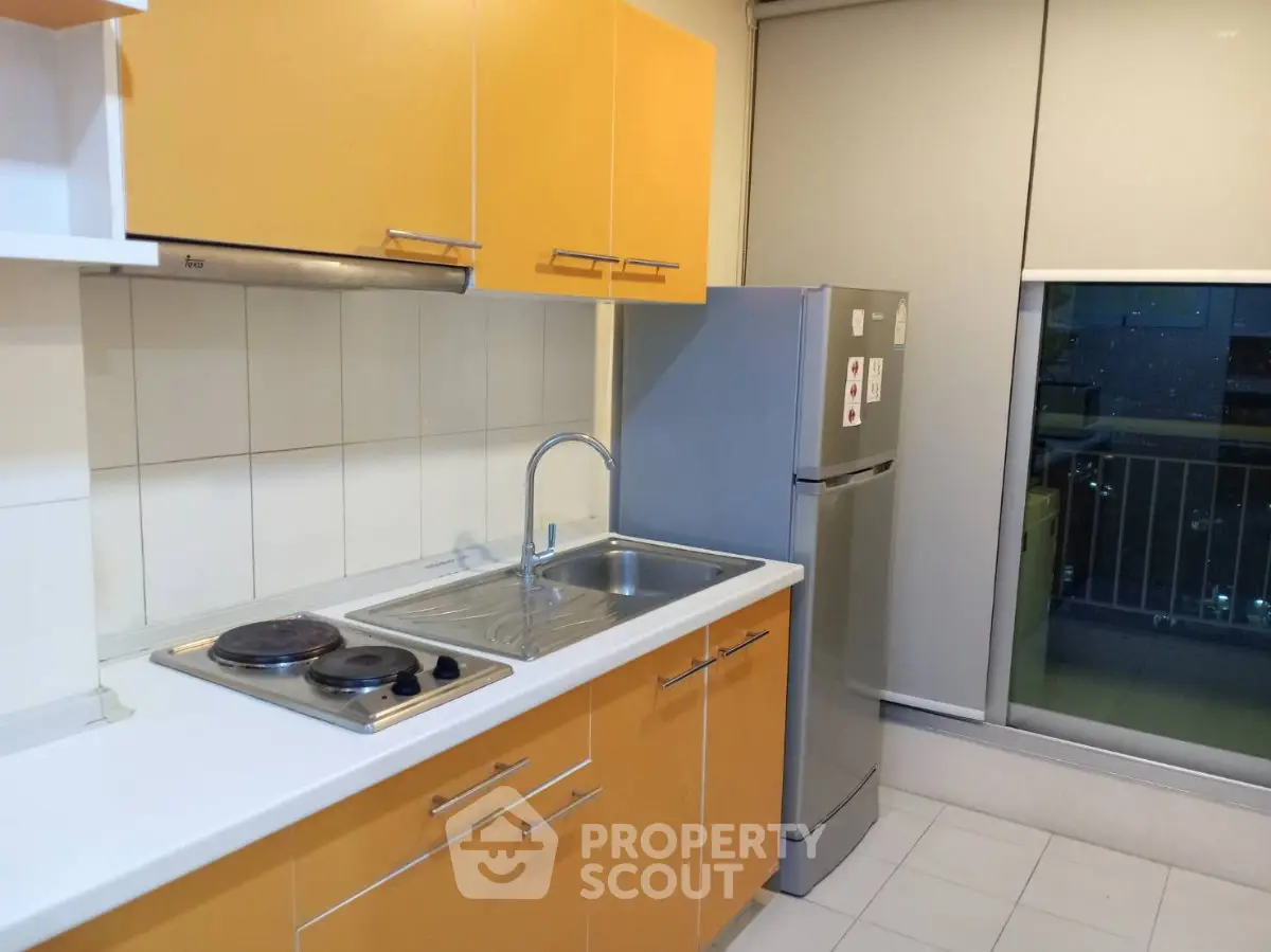 Modern kitchen with vibrant yellow cabinets and sleek stainless steel appliances