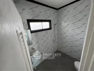 Modern bathroom with sleek tile design and compact layout
