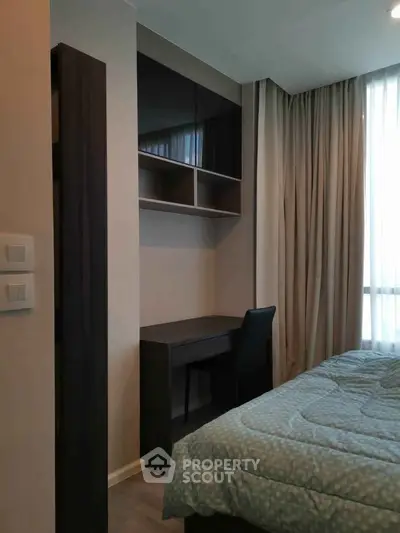 Cozy bedroom with study area, featuring a modern desk and comfortable bedding, ideal for relaxation and productivity.