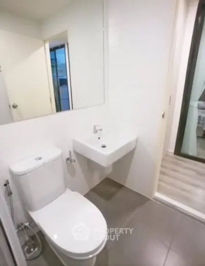 Modern bathroom with sleek fixtures and minimalist design in a contemporary apartment.
