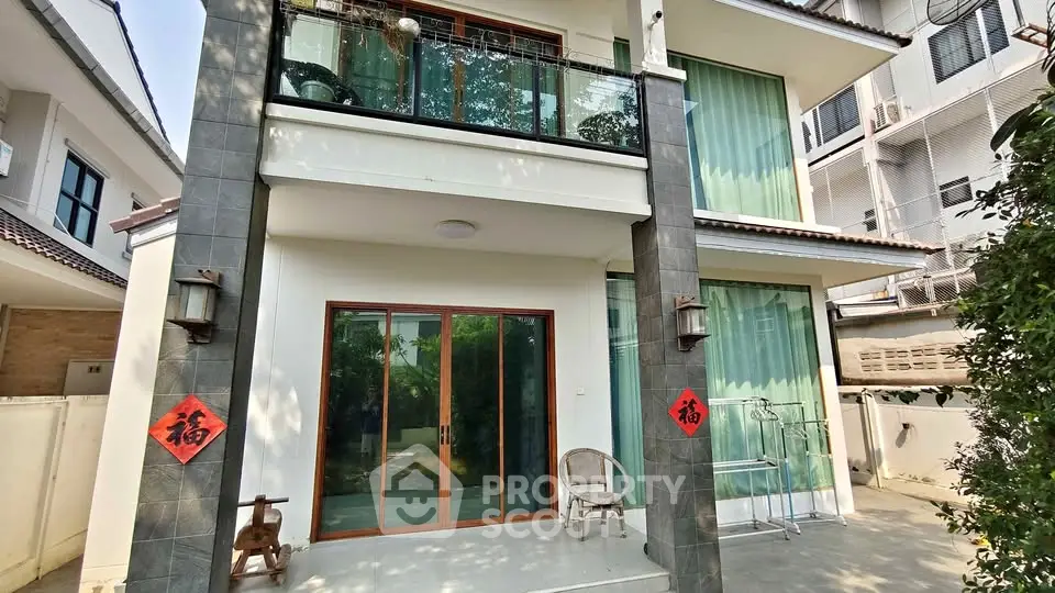 Charming two-story house with modern design and spacious balcony in a serene neighborhood.
