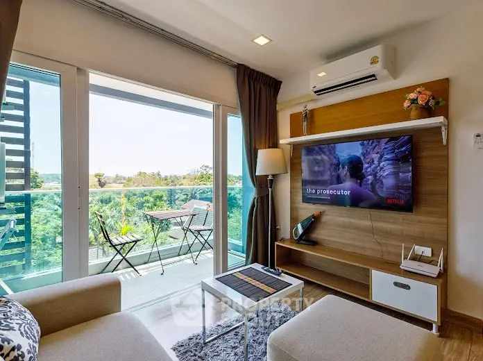 Modern living room with balcony view, stylish furniture, and natural light.