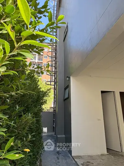 Modern building exterior with lush greenery and sleek design